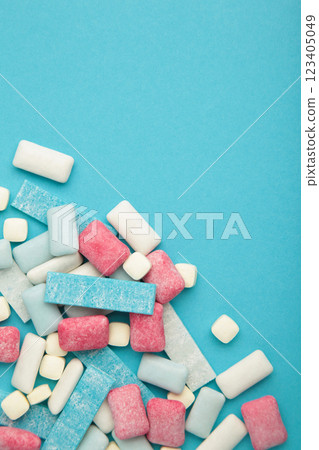 Different chewing gums on blue background. Vertical photo 123405049