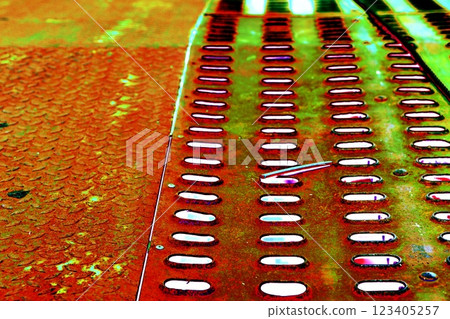 The surface of a rusty steel plate with rows of holes. Steel macro background. Changed color scheme. The surface of a rusty steel plate with rows of holes. Steel macro background. Changed color scheme. 123405257