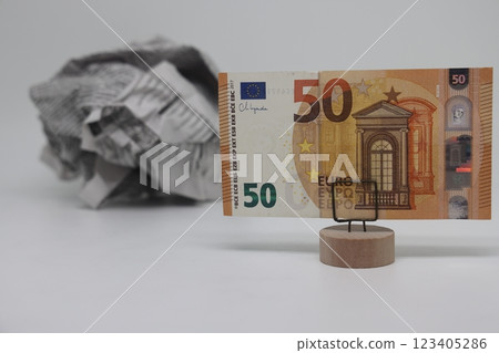 Banknote on the background of a crumpled piece of newspaper on a white background, fake news 123405286