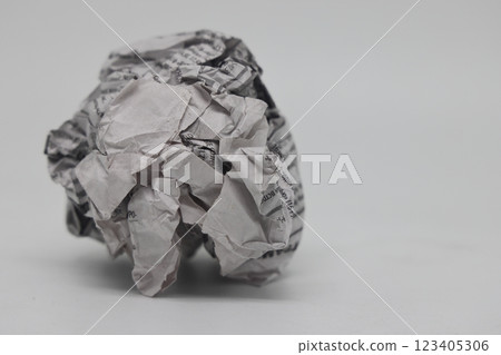 A crumpled piece of newspaper on a white background, fake news, corrupt journalism. A crumpled piece of newspaper on a white background, fake news, corrupt journalism. 123405306