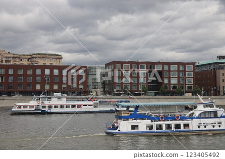 Moscow, Russia - June 2022: River pleasure boat on the Moscow river and Frunzenskaya embankment. Moscow, Russia - June 2022: River pleasure boat on the Moscow river and Frunzenskaya embankment. 123405492