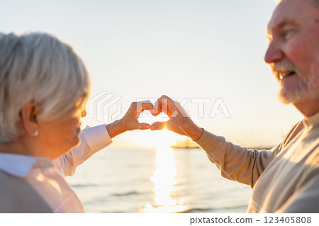 Love heart shape peace. Senior older couple making heart shape with their hands. Adult mature old husband wife showing heart sign. Happy pensioner family. I love you happy valentines day 123405808