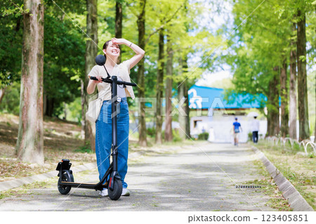 Women's trip: A woman sightseeing on an electric kickboard Women's trip: A woman sightseeing on an electric kickboard 123405851