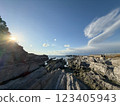 The sun setting on the winter coastline and the dragon god 123405943