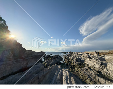 The sun setting on the winter coastline and the dragon god 123405943