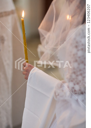 An Elegant Bride Holding a Candle During a Beautiful Wedding Ceremony Celebration Event An Elegant Bride Holding a Candle During a Beautiful Wedding Ceremony Celebration Event 123406207