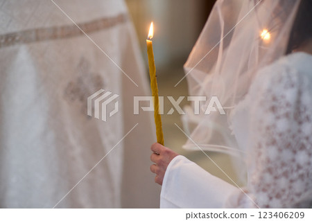 An Elegant Bride Holding a Candle During a Beautiful Wedding Ceremony Celebration Event An Elegant Bride Holding a Candle During a Beautiful Wedding Ceremony Celebration Event 123406209