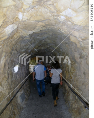 A man and a woman go into the cave. The Limestone caves and underground grottoes Rosh Hanikre in Israel A man and a woman go into the cave. The Limestone caves and underground grottoes Rosh Hanikre in Israel 123406349