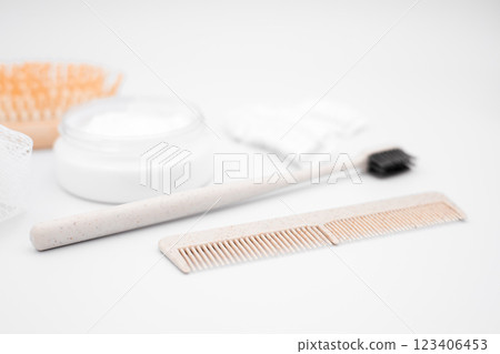 Minimalist bathroom set with toothbrush, comb, and cream 123406453