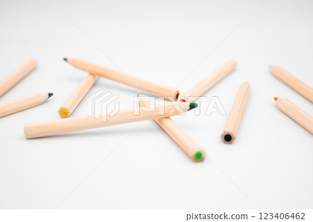 Scattered wooden colored pencils on white background 123406462