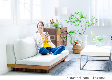 Young woman drinking coffee in the living room 123408608