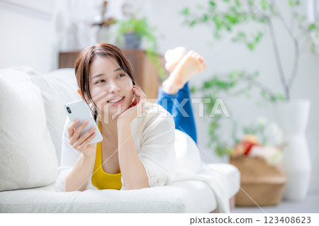Young woman looking at a smartphone 123408623