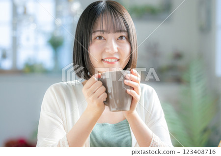 A woman drinking coffee A woman drinking coffee 123408716