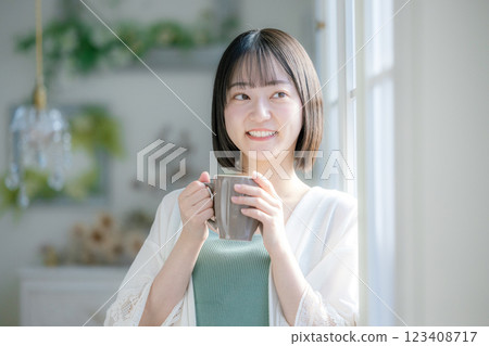 A woman drinking coffee A woman drinking coffee 123408717