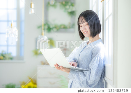 A young woman using a personal computer in the room 123408719