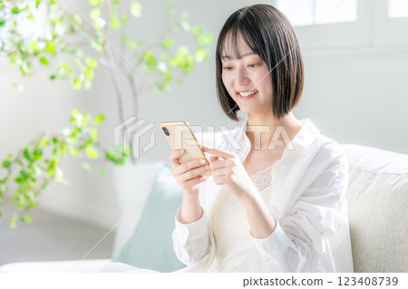 A woman watching a smartphone A woman watching a smartphone 123408739