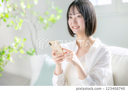 A woman watching a smartphone A woman watching a smartphone 123408740