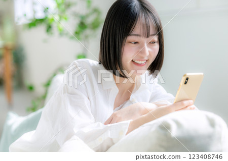 A woman watching a smartphone 123408746
