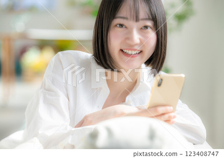 A woman watching a smartphone A woman watching a smartphone 123408747