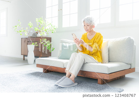 Senior woman looking anxiously at her smartphone 123408767