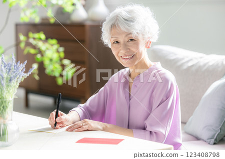 Senior woman writing a letter Senior woman writing a letter 123408798