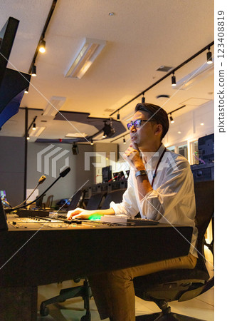 A man working at a TV station A man working at a TV station 123408819