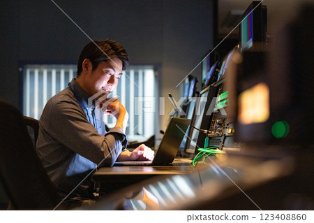 A man working at an office at night A man working at an office at night 123408860