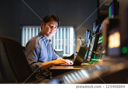 A man working at an office at night A man working at an office at night 123408864