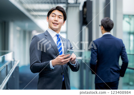 A businessman operating a smartphone at the office 123408984
