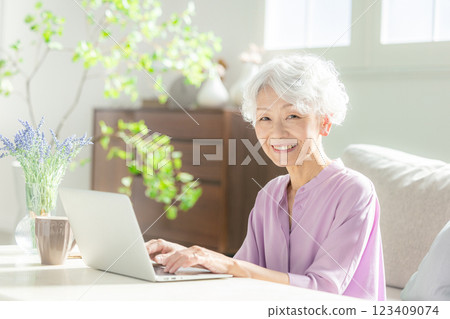 A senior woman operating a computer A senior woman operating a computer 123409074
