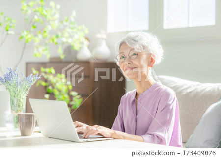 A senior woman operating a computer A senior woman operating a computer 123409076
