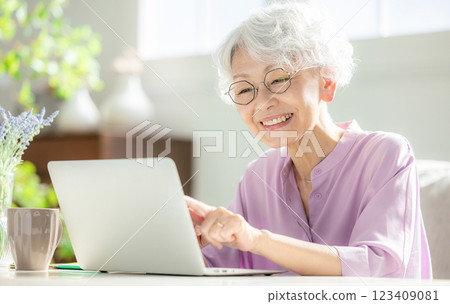 A senior woman operating a computer A senior woman operating a computer 123409081