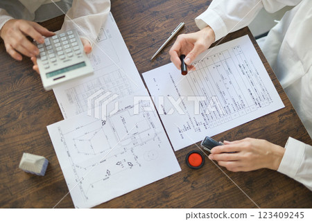 The hands of two women signing a real estate contract 123409245