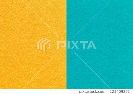 Texture craft yellow and turquoise paper background, half two colors, macro. Structure vintage blue cardboard. 123409291