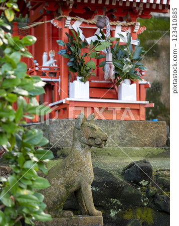 The Inari Shrine's fox guardian deity and a small shrine The Inari Shrine's fox guardian deity and a small shrine 123410885