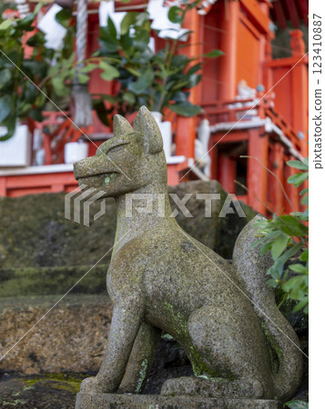 The Inari Shrine's fox guardian deity and a small shrine The Inari Shrine's fox guardian deity and a small shrine 123410887