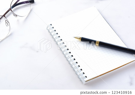 An image of doing desk work with a ring-type notepad and pen An image of doing desk work with a ring-type notepad and pen 123410916