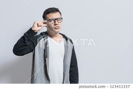People gesturing with his hand showing something small size with his fingers. man measuring something with fingers, Person showing a small amount with his fingers 123411337