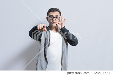 A person signaling you to keep a secret, People zipping their mouth, man gesturing to keep a secret, isolated people zipping silence A person signaling you to keep a secret, People zipping their mouth, man gesturing to keep a secret, isolated people zipping silence 123411347