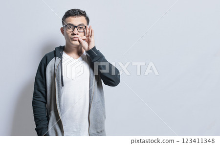 Isolated people zipping silence. A person signaling you to keep a secret, People zipping their mouth, man gesturing to keep a secret Isolated people zipping silence. A person signaling you to keep a secret, People zipping their mouth, man gesturing to keep a secret 123411348