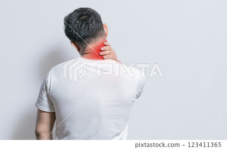 Close up of person with shoulder and neck problems, sore man touching his shoulder on isolated background, lumbar and muscular problems concept Close up of person with shoulder and neck problems, sore man touching his shoulder on isolated background, lumbar and muscular problems concept 123411365