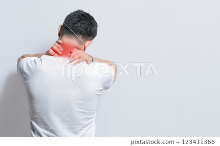 Close up of person with shoulder and neck problems, sore man touching his shoulder on isolated background, lumbar and muscular problems concept Close up of person with shoulder and neck problems, sore man touching his shoulder on isolated background, lumbar and muscular problems concept 123411366
