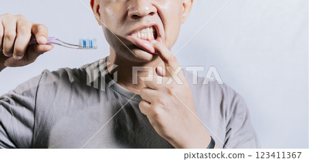 Person with gingivitis holding toothbrush. People holding toothbrush with gum pain. Man holding toothbrush with gum pain, People holding toothbrush with gum problem isolated 123411367