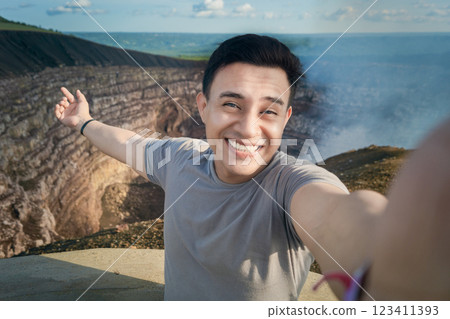 Tourist taking a selfie at a viewpoint. Handsome tourist taking a selfie on vacation. Adventurous man taking a selfie at a viewpoint. Close up of person taking an adventure selfie Tourist taking a selfie at a viewpoint. Handsome tourist taking a selfie on vacation. Adventurous man taking a selfie at a viewpoint. Close up of person taking an adventure selfie 123411393