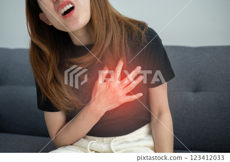 Asian woman having chest pain problem. Chest pain has many causes, like issues in your heart, lungs or digestive system. Asian woman having chest pain problem. Chest pain has many causes, like issues in your heart, lungs or digestive system. 123412033