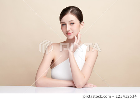 Beautiful young woman with clean fresh skin on beige background, Face care, Facial treatment, Cosmetology, beauty and spa, women portrait. 123412534