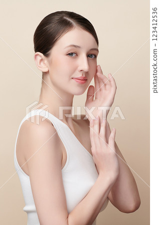 Beautiful young woman with clean fresh skin on beige background, Face care, Facial treatment, Cosmetology, beauty and spa, women portrait. Beautiful young woman with clean fresh skin on beige background, Face care, Facial treatment, Cosmetology, beauty and spa, women portrait. 123412536