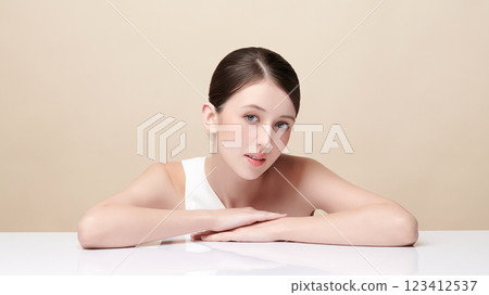 Beautiful young woman with clean fresh skin on beige background, Face care, Facial treatment, Cosmetology, beauty and spa, women portrait. 123412537