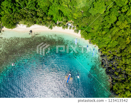 Sun reflection over the boats on clear water. Pasandigan Cove. Cadlao, El Nido, Palawan. Philippines. 123413542