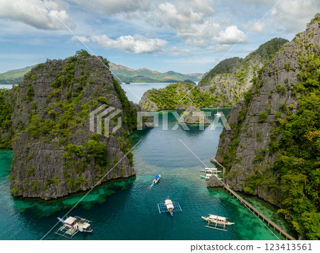 Boats over green water surrounded by splendid limestone rocks in islands. Kayangan Lake. Coron, Palawan. Philippines. Boats over green water surrounded by splendid limestone rocks in islands. Kayangan Lake. Coron, Palawan. Philippines. 123413561